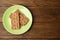 Plate with rye crispbreads on wooden table, top view. Space for text