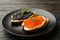 Plate with sandwiches with caviar on wooden background, closeup