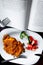 Plate with schnitzel and salad and open book