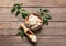 Plate and scoop with shea butter on wooden background