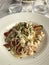 Plate of seafood â€˜spaghetti allo scoglioâ€™ pasta in a restaurant on the Italian Riviera