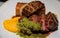 Plate of seared duck breast and foie gras with a side of potato gratin and sweet potato puree  at a restaurant in Porto