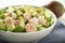 A plate of shrimp and avocado salad with a zesty dressing.