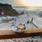 Plate of shrimps with Guincho beach in Cascais, Portugal in background