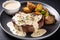 plate of sizzling steak, topped with rich creamy garlic sauce and paired with roasted potatoes