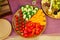 plate with slicing of tomatoes, cucumbers, sweet peppers and cherry tomatoes.