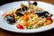 Plate with spaghetti, mussels and cherry tomato