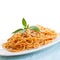 Plate of spaghetti in tomato sauce with basil