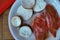 Plate with spiced lamb chops and cassava slices on a wooden table