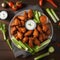 A plate of spicy buffalo chicken wings with celery and ranch dip4