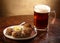 Plate of spicy meatballs served with beer