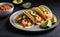 A plate of spicy shrimp tacos with salsa and avocado