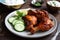 plate of spicy tandoori chicken with side of cool cucumber raita