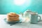 Plate with stack of delicious thin pancakes, butter and tea on light table