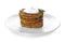 Plate with stack of zucchini pancakes and sauce isolated on white