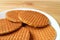 Plate of Stroopwafel Cookies, Tasty Dutch Traditional Sweets served on wooden table