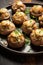 A plate of stuffed mushrooms on a wooden table