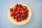 Plate with summer ripe berries - strawberries, strawberries, raspberries. Vitamin delicious simple natural vegan juicy dessert