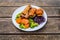 Plate of Sunday roast on vintage wooden surface, traditional British meal of roasted meat, roast potatoes, Yorkshire pudding,