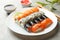 Plate with sushi rolls on background. Japanese food