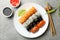 Plate with sushi rolls on background. Japanese food