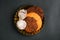 Plate with sweet pastries on a black background. Close-up of cookies of different shapes and types.