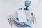 A plate on a table with a knife, a fork and flowers.  Elegant table setup in blue pastels