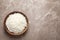 Plate of tasty cooked rice on color background, top view.