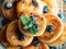 Plate with tasty fluffy pancakes with blueberries, honey