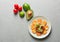 Plate with tasty guacamole, rusks and fresh vegetables on textured background