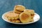 Plate of tasty imperfect homemade cookies on deep blue background