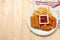 Plate with tasty ketchup, fries, chicken nuggets and cheese sticks on wooden table, top view. Space for text