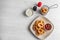 Plate with tasty onion rings and sauces on table