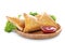 Plate with tasty samsa and sauce on white background