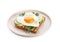 Plate of tasty sandwich with heart shaped fried egg isolated