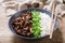 plate of teriyaki beef, rice, green onion and sesame seeds