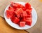 In plate there is small portion of watermelon pulp, useful cubes