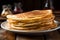 Plate of thin pancakes, close up on a wooden background