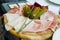 Plate of three kinds of ham with large pickles