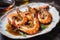 plate of tiger shrimp prawns, drizzled with garlic-infused oil