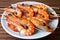 plate of tiger shrimp prawns, skewered and ready to grill