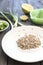 Plate of uncooked farro grains with onions, lemons and butter