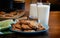 Plate of warm chocolate chip cookies and glass of milk