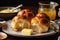 plate of warm, fluffy rolls with drizzle of melted butter and slice of cheese