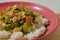 A plate of white rice with stir fried gambas or luffa gourd and sliced meatballs