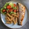 plate of wholemeal tomato pasta with trout, salad and wholemeal bread. Keto diet lunch