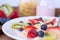 Plate with yogurt, cereals, strawberries, blueberries and kiwi - macro