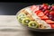 Plate with yogurt, muesli, kiwi, strawberries, and banana a wholesome breakfast