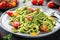 plate of zucchini noodles with creamy pesto sauce and cherry tomatoes