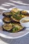 Plateful of Fried Sliced Aubergine or Eggplant Covered with Fresh Flat Leaf Parsley